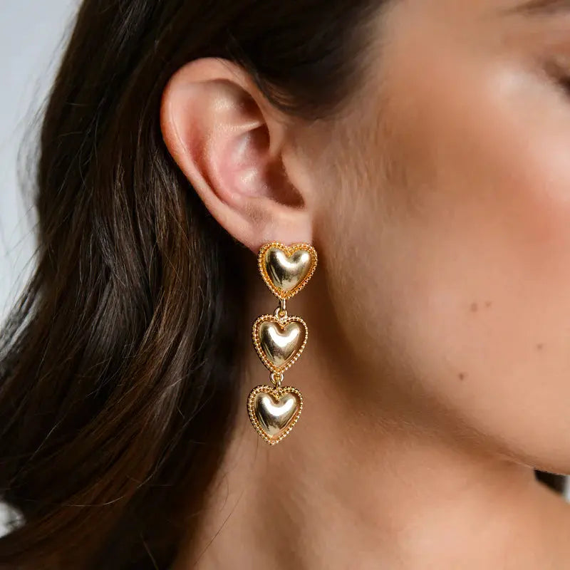 Model wearing Maeva Earrings - Gold heart earrings by Margot Bardot Online
